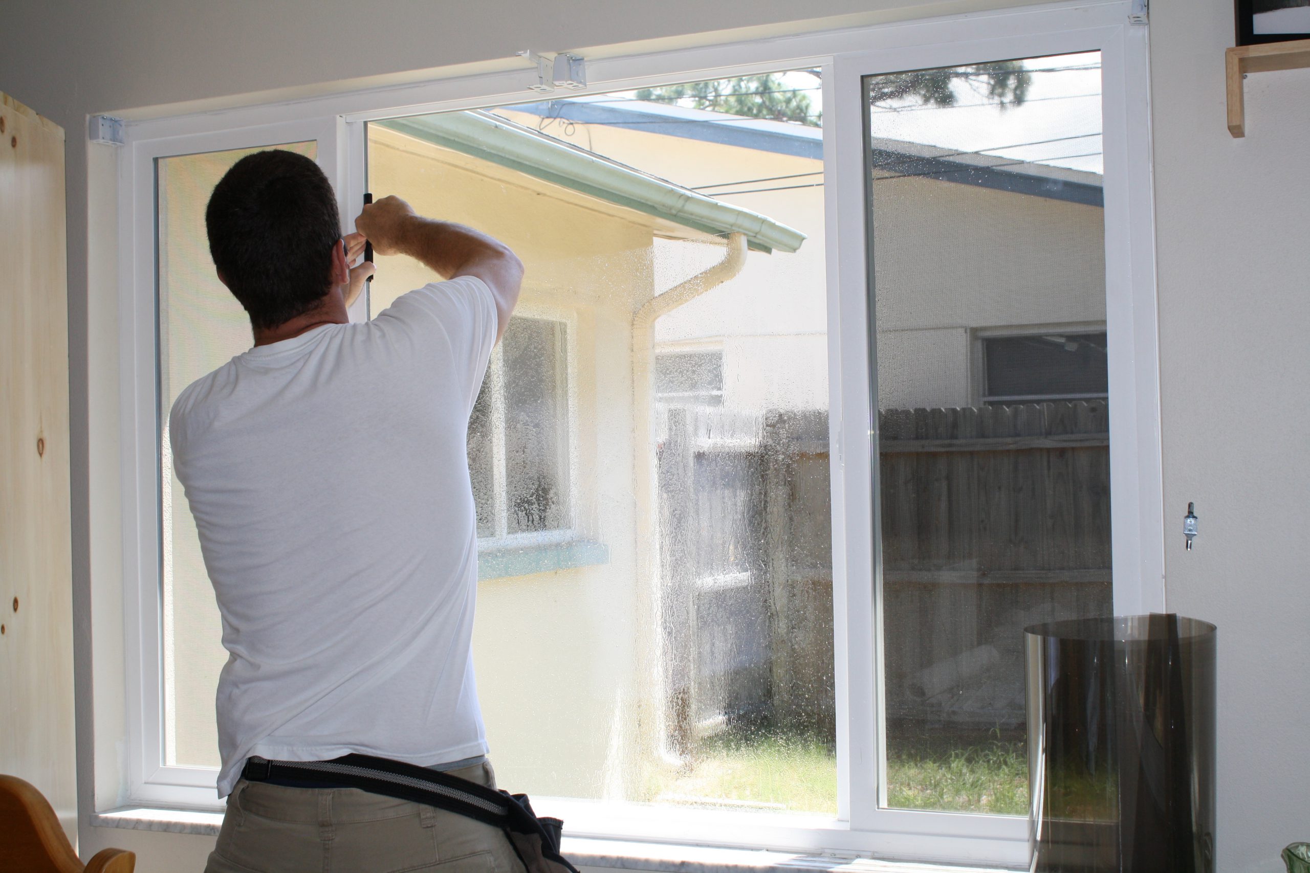 Window tint being applied to a home's windows