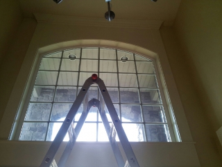 Ladder in front of high entryway windows