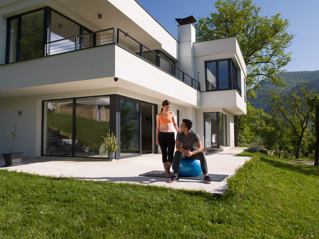 Window film on a modern house exterior shot with a couple on back patio.