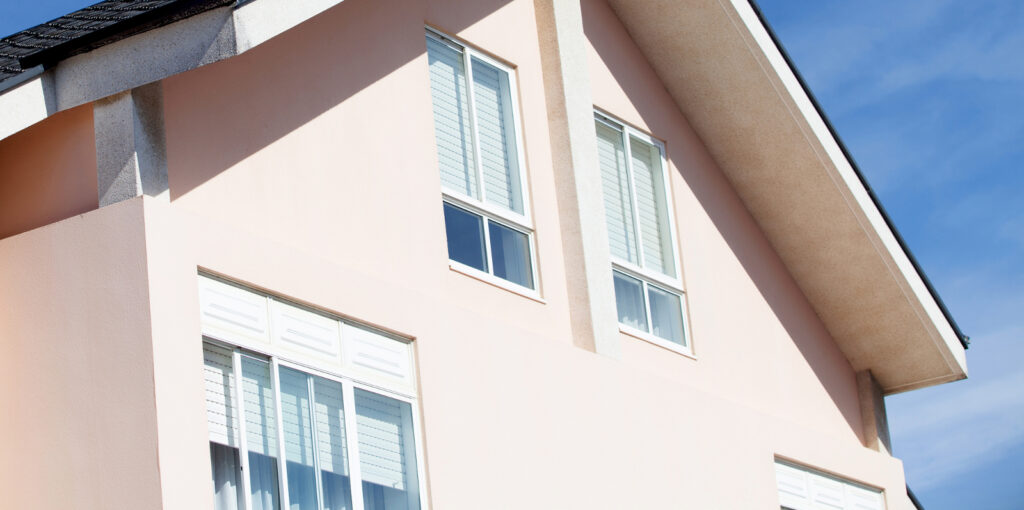 Facade of a beautiful house with a gabled roof tile black to illustrate how much heat do windows lose