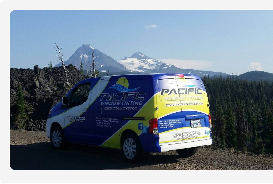 Pacific Window Tinting van on a backwoods road with mountains in the background