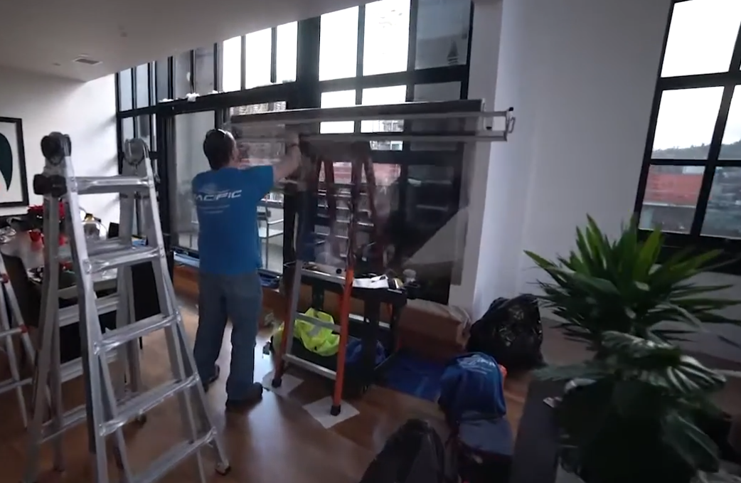 Pacific Window Tint crew installing window film in a residence to help illustrate sun blocking window film